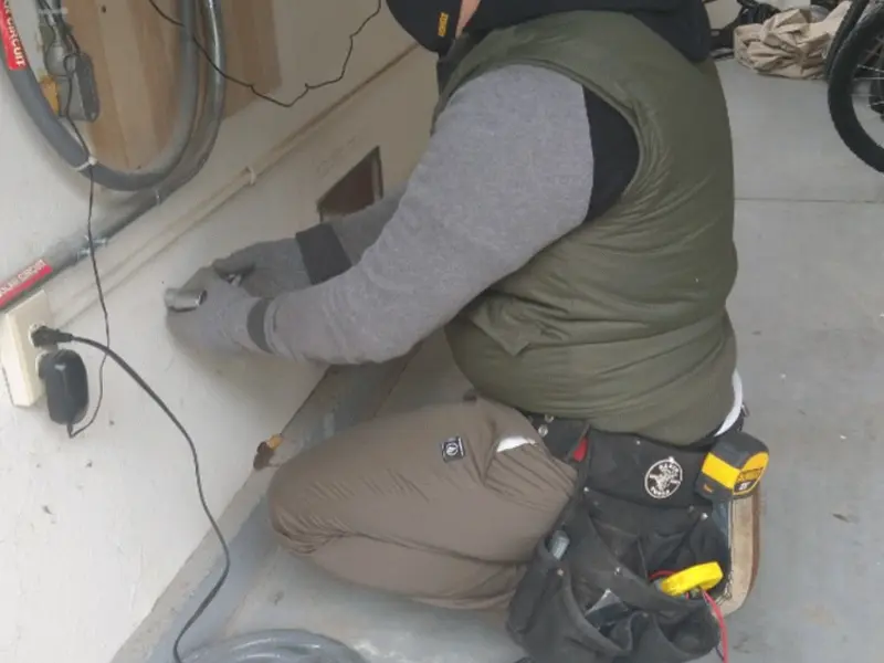 Electrician performing outlet wiring in a High Springs garage